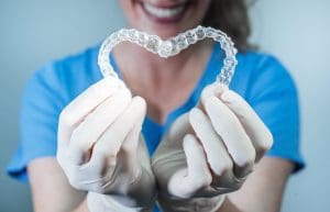 A heart made with two aligners Invisalign at Aesthetic Dental Studio